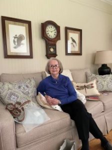 Mary Bess Paluzzi sitting down on a couch in her home