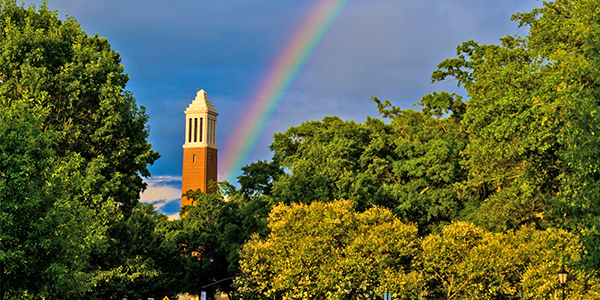Denny Chimes with a rainbow behind it