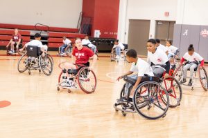 group playing wheelchair basketball