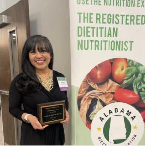 sheena gregg holding an award for her work as a dietitian