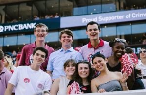 a group of students are standing and posing inside of bryant denny stadium for a group picture